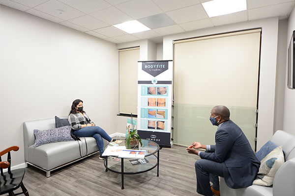 Dr. Perryman consulting with a patient about FaceTite and BodyTite at the Napa office.